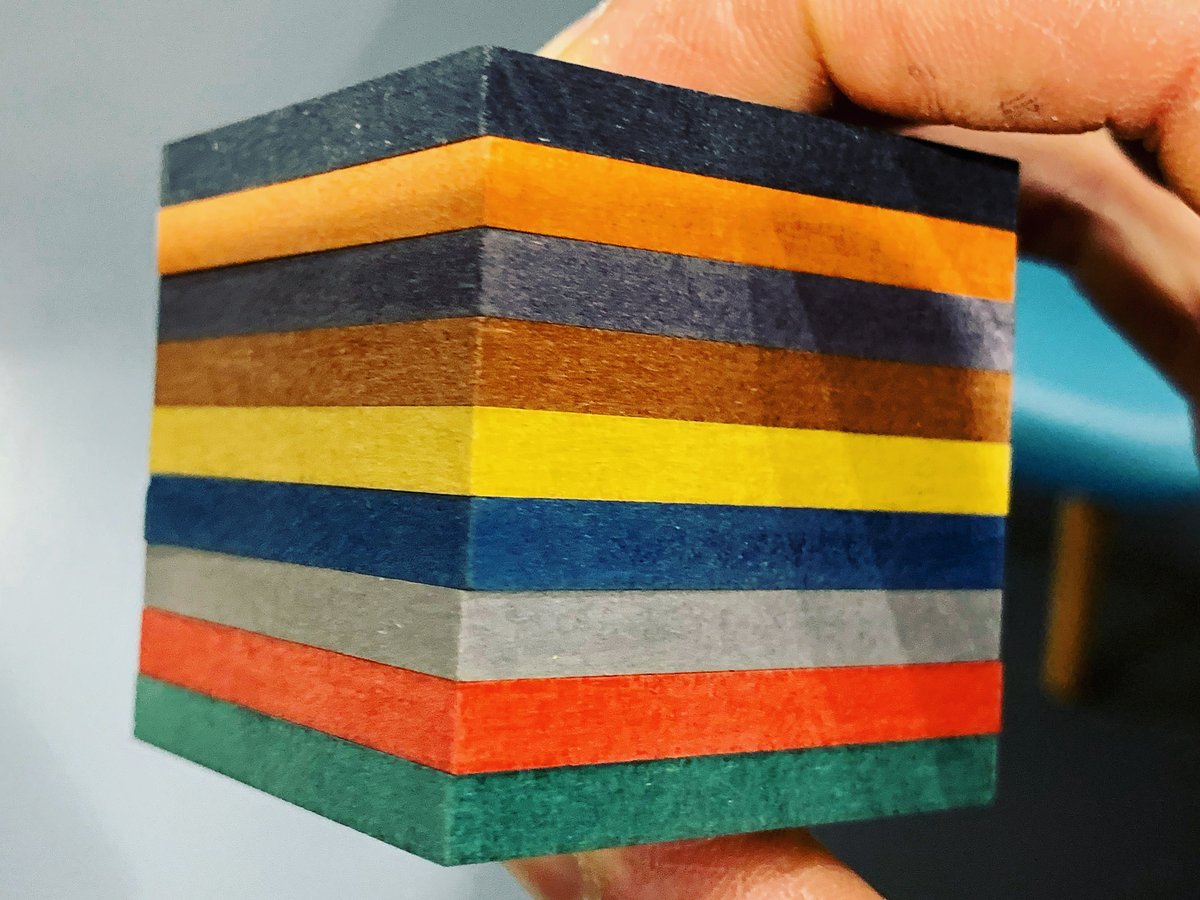A cube of stacked Valchromat samples in nine colours